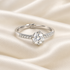 Round Moissanite solitaire with stone-set band on ivory satin