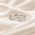 Moissanite ring on ivory satin with overlapping adjustable band