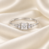 Princess-cut Moissanite ring on ivory satin